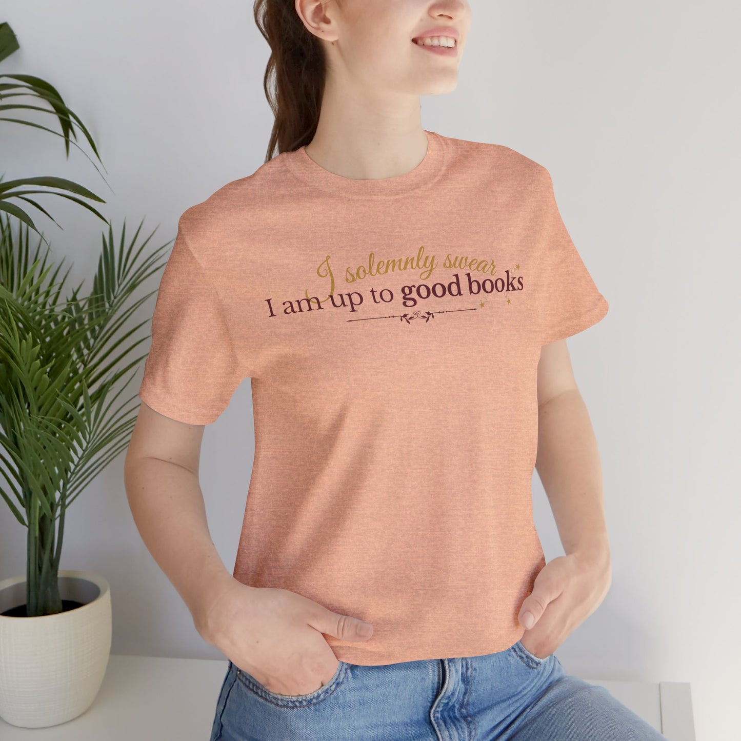 "I solemnly swear I am up to good books"; in a clean and enchanting design on a lightweight unisex tee